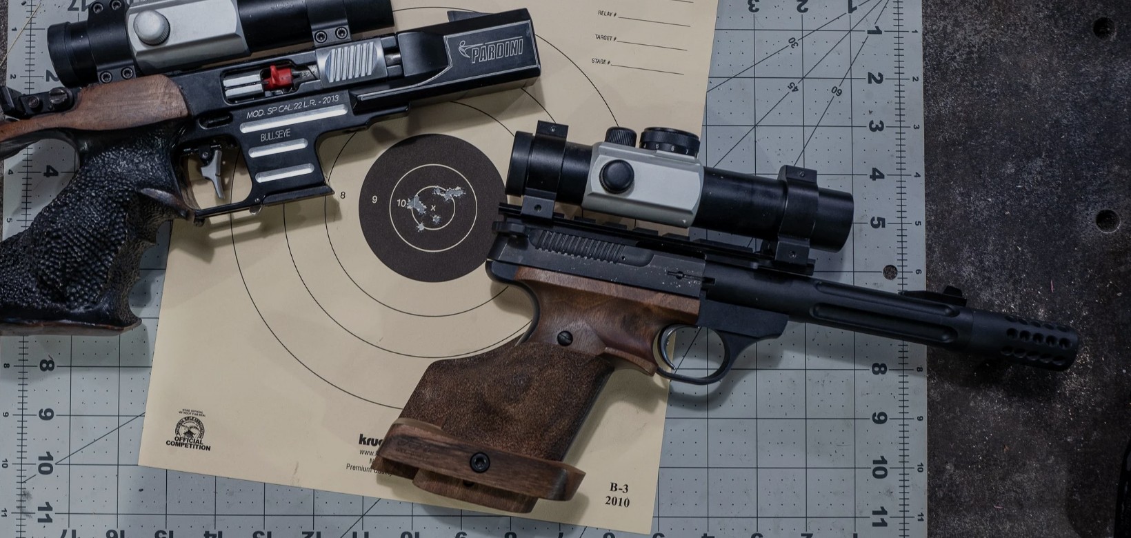 Precision pistols resting on a competition target inside the PRPC range