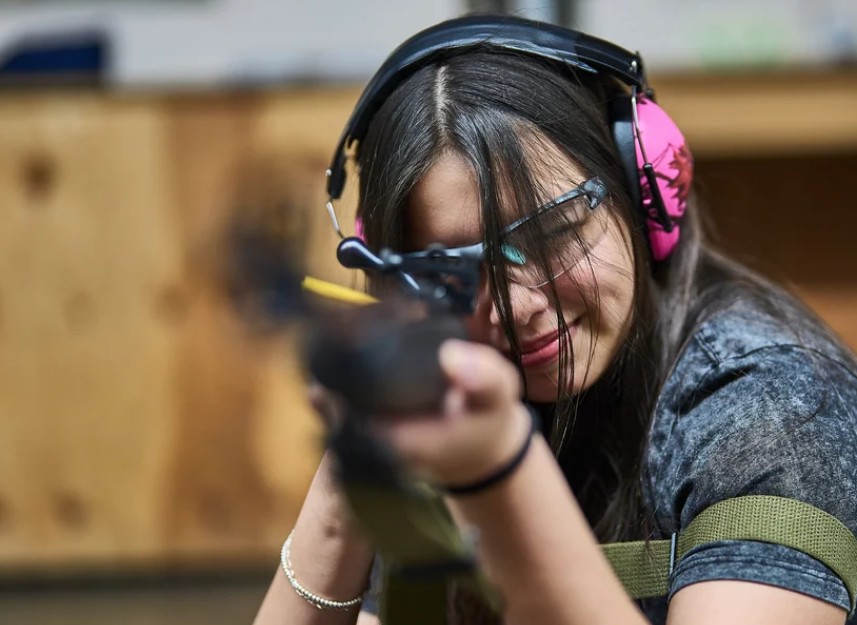 A young member of the PRPC Juniors Program sighting a rifle